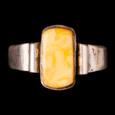 Srebrny pierścionek z żółtym kamieniem.